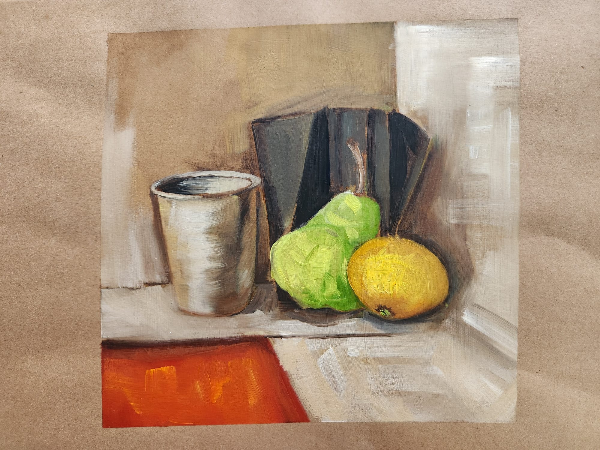 Still-life study with a metal cup, a dark book, a green pear and a yellow lemon on kraft paper